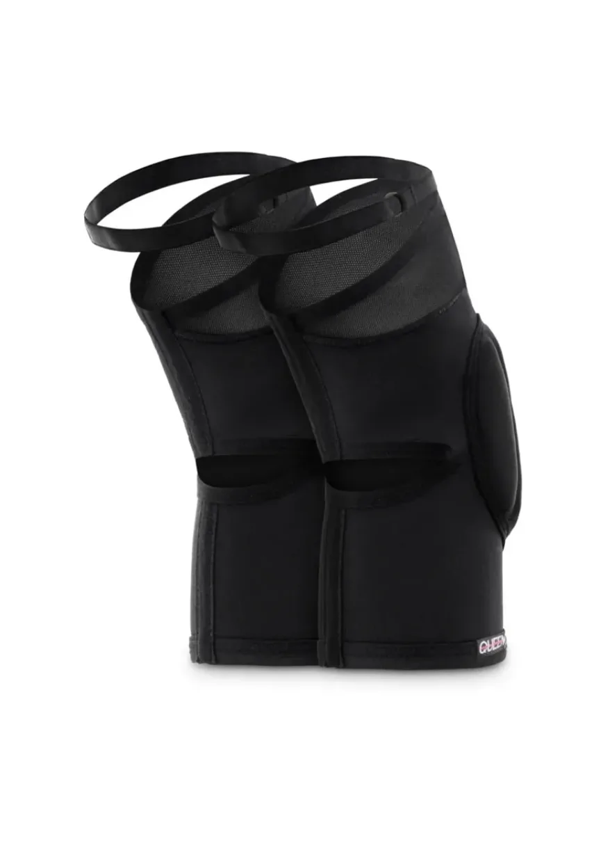 Pair of black adjustable shin guards with velcro straps standing upright, athletic protective gear for the legs.