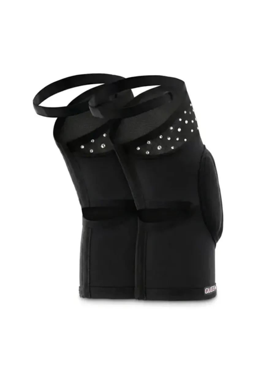 Pair of black elbow pads with adjustable straps and metal studs along the top edge for decoration and protection.